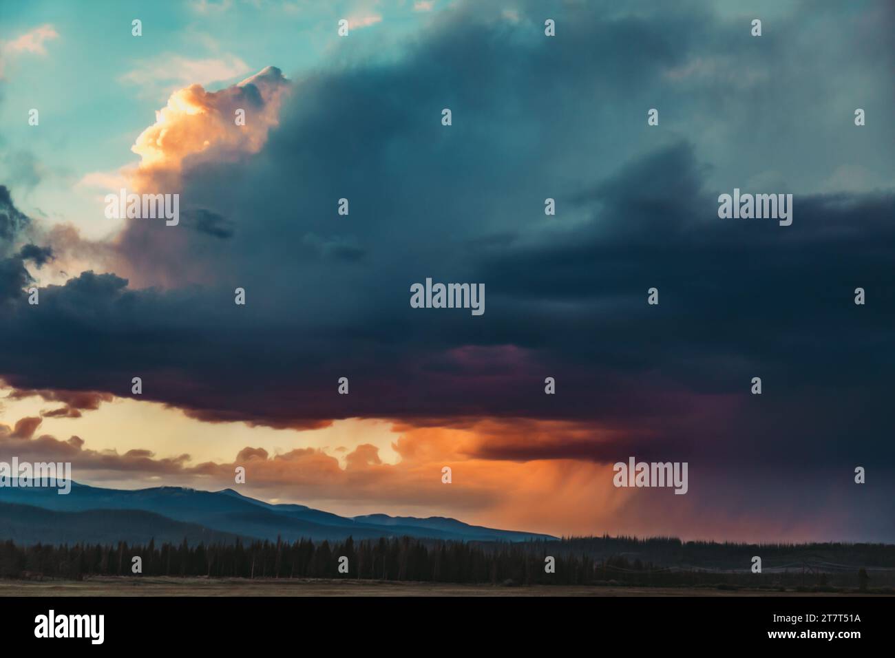 Storm clouds over the mountains with sunset Stock Photo