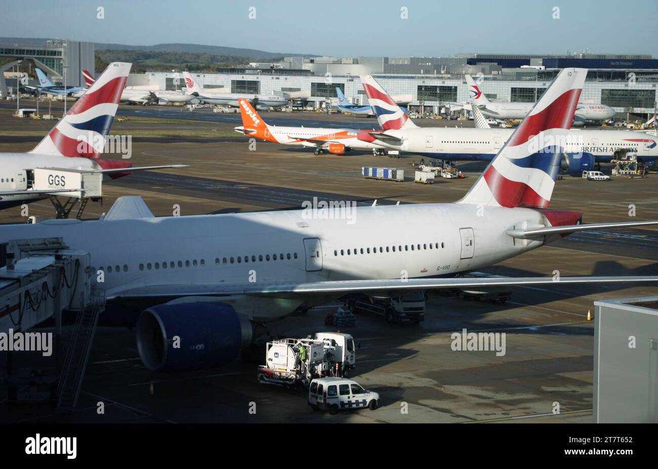 A view from the South Terminal at Gatwick Airport looking towards the North Terminal including the air bridge extension and a variety of aircraft Stock Photo