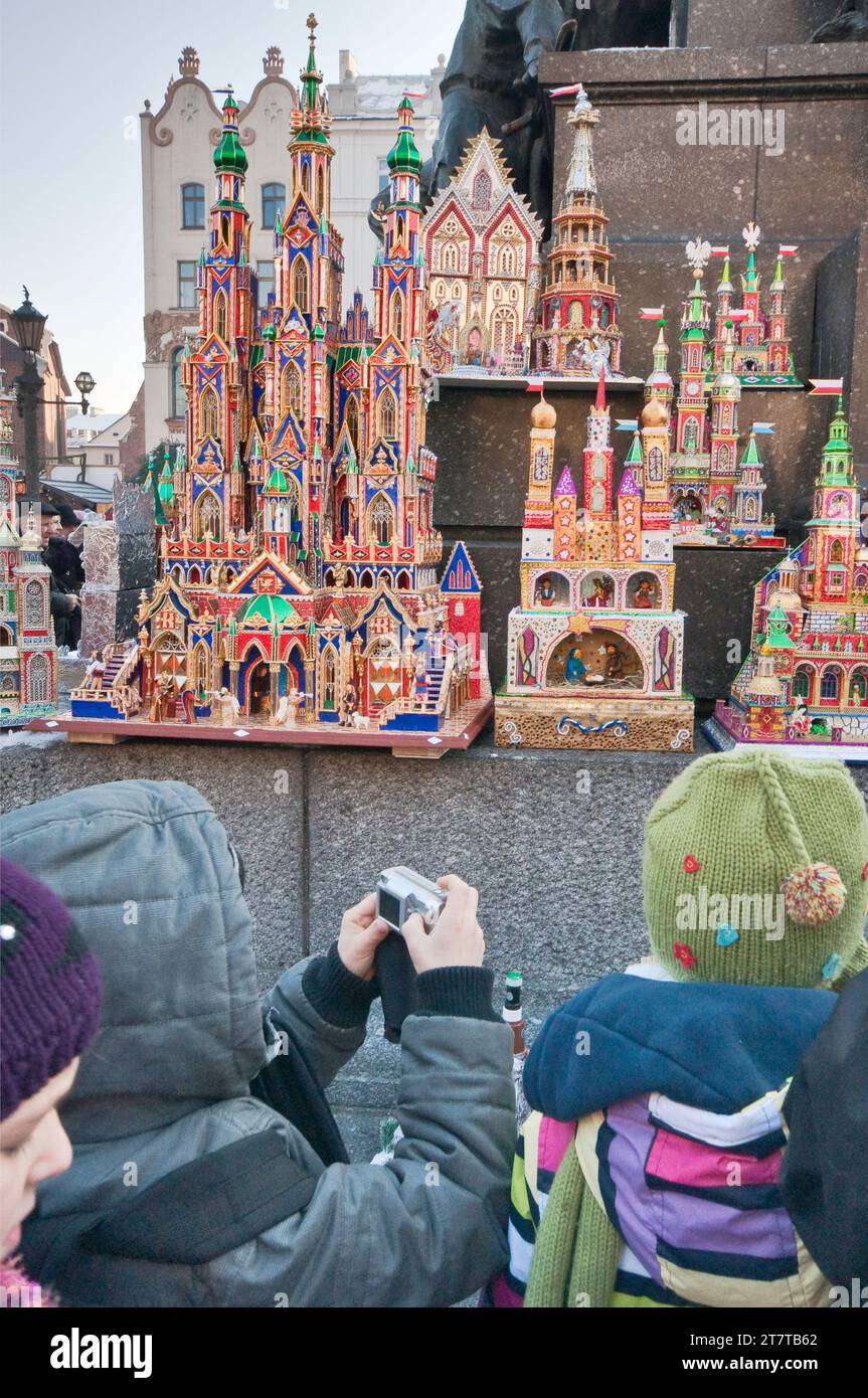 Children at Szopki or Christmas Nativity scenes display shown at annual competition in December at Rynek Glowny or Main Market Square, Krakow, Poland Stock Photo