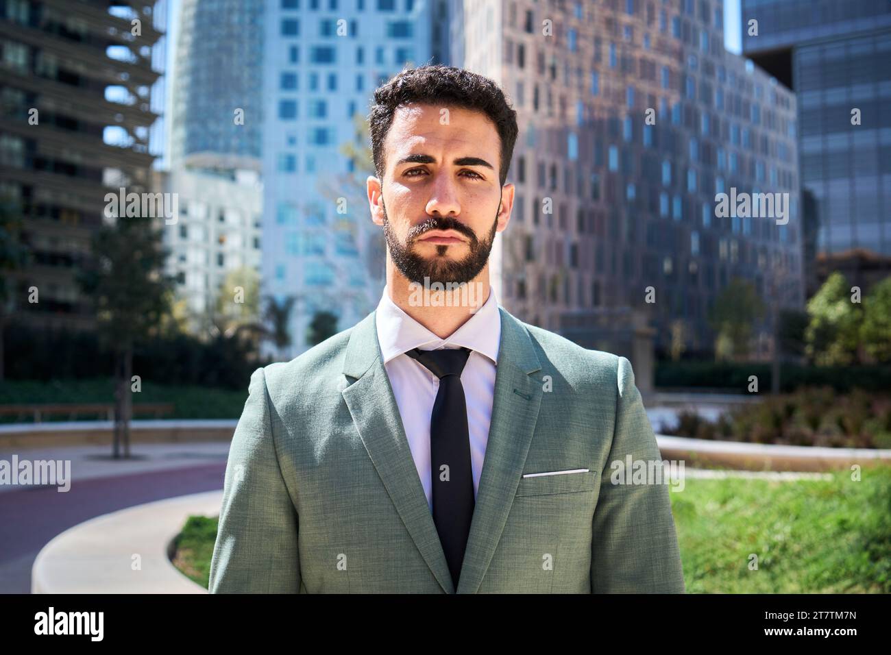 Portrait of young adult Caucasian handsome business man serious expression in formal wear outdoors. Stock Photo