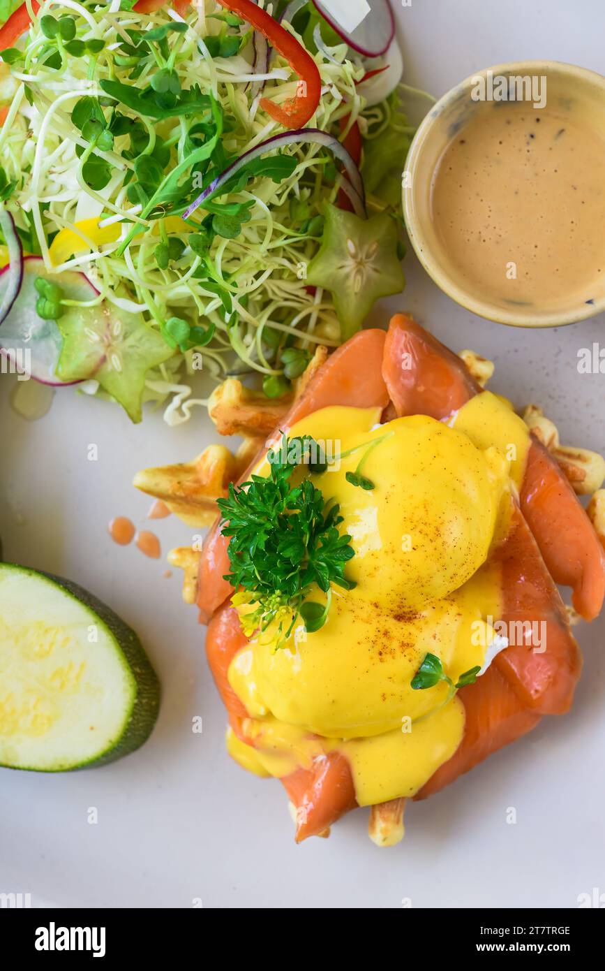 white plate with eggs bennedict waffles with smoked salmon on a white background Stock Photo