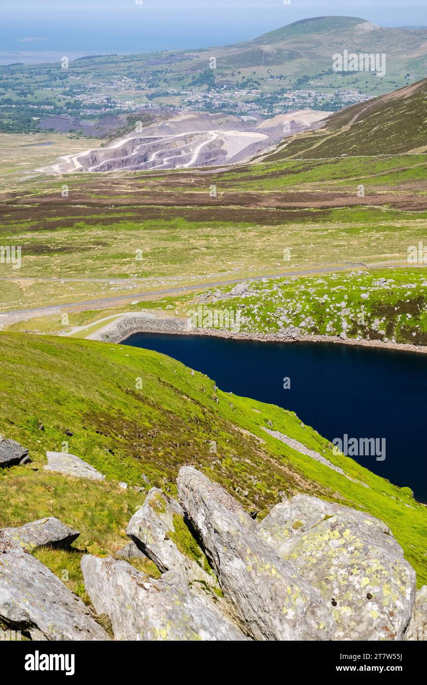 View from above Marchlyn Bach reservoir to Penrhyn slate quarry workings and Bethesda on descent from Elidr Fawr. Dinorwig Llanberis Gwynedd Wales UK Stock Photo