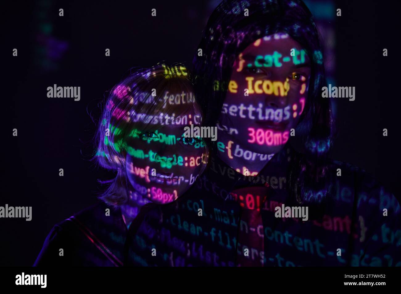 portrait of futuristic couple with neon programming lettering on dark ...