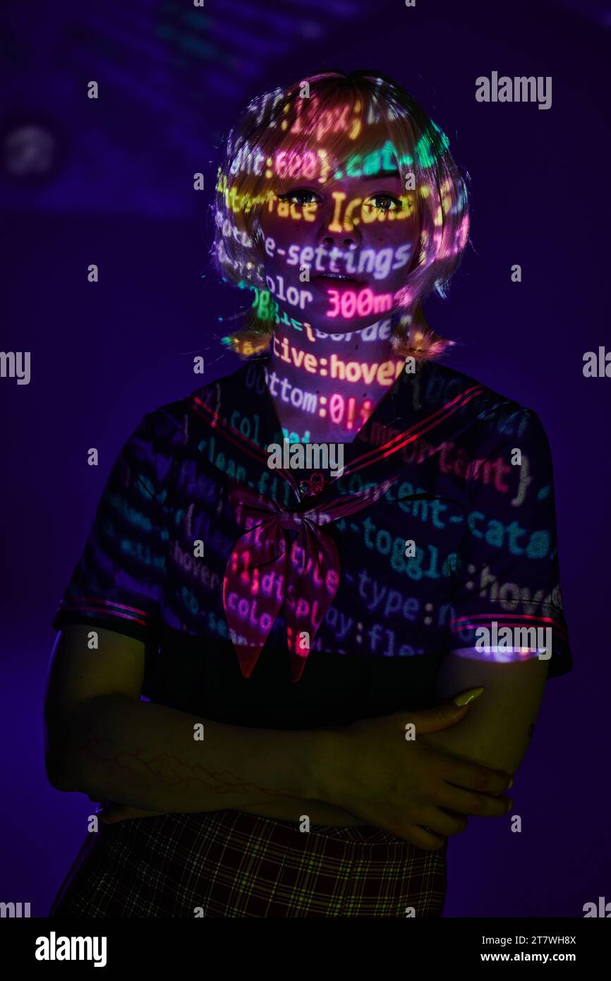 woman in students uniform in neon programming symbols projection on ...