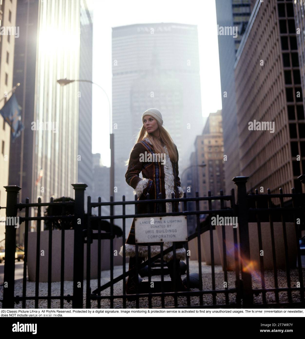 1970s lifestyle and fashion. A young woman wearing a typical 1970s coat in this photo taken on Manhattan New York with the Pan Am building in the background. Her name is Marita Lindholm, fashion model. 1971 Stock Photo
