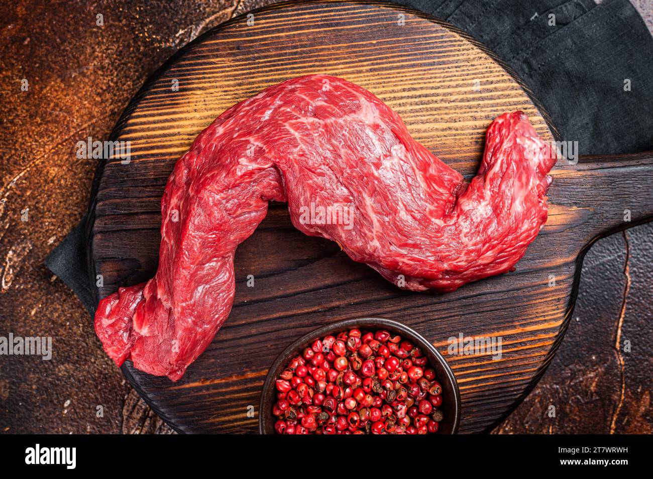 Raw Skirt Machete beef meat steak on wooden board. Dark background. Top view. Stock Photo