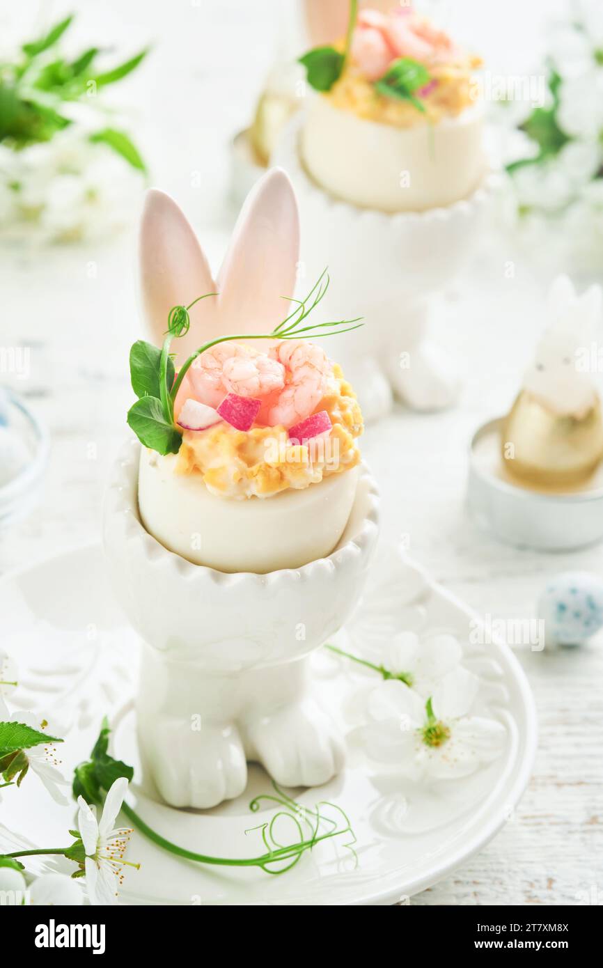 Stuffed or deviled eggs with yolk, shrimp, pea microgreens with paprika ...