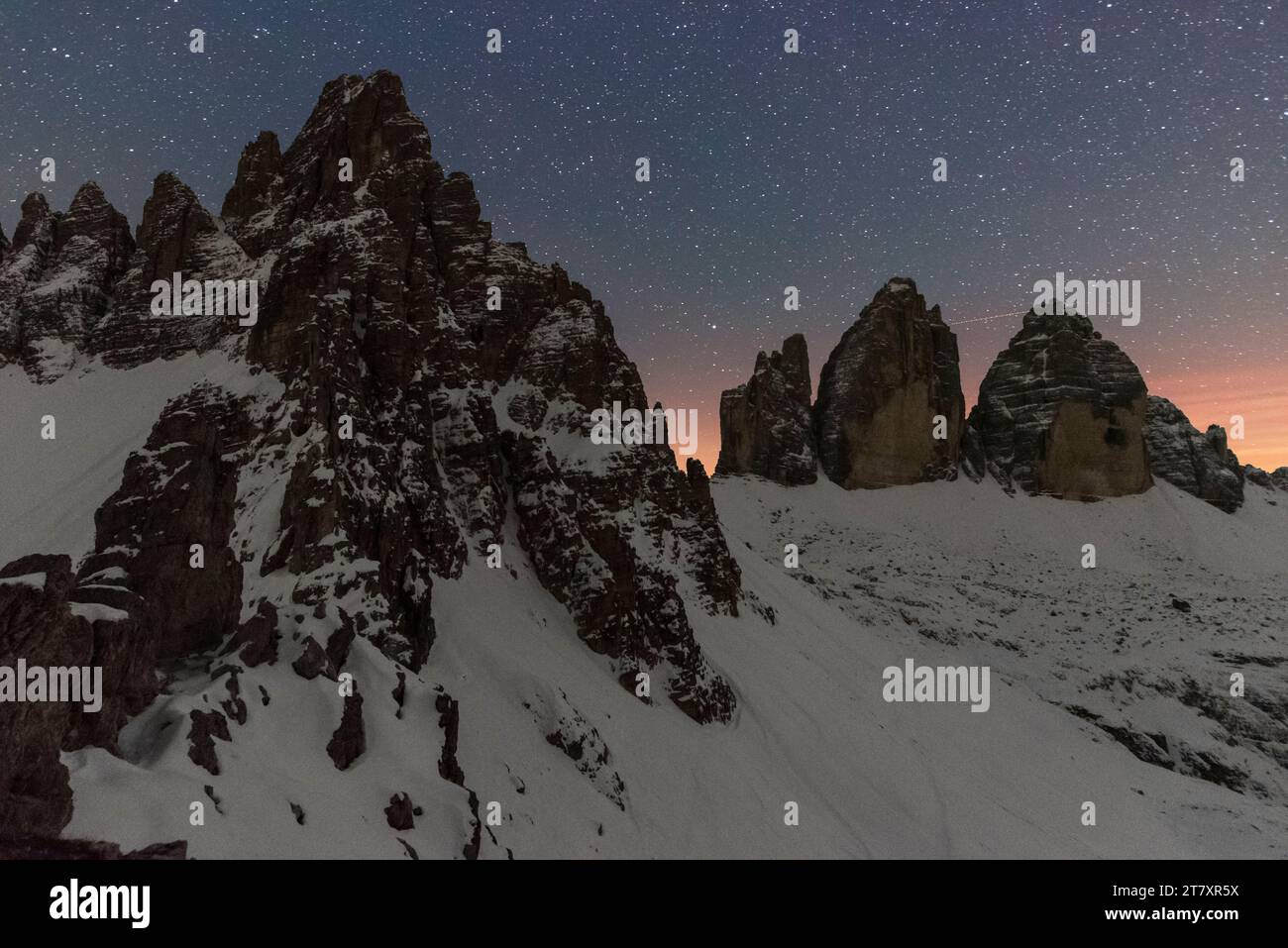 Starry night over Tre Cime di Lavaredo (Lavaredo peaks) and Paterno mountain, winter view, Sesto (Sexten), Dolomites, South Tyrol, Italy, Europe Stock Photo