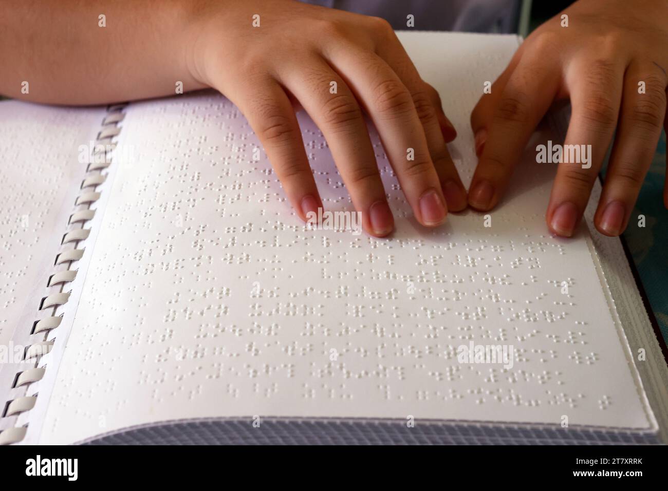 Close up on hands of blind girl reading braille book, Center for Blind Children, Ho Chi Minh City, Vietnam, Indochina, Southeast Asia, Asia Stock Photo