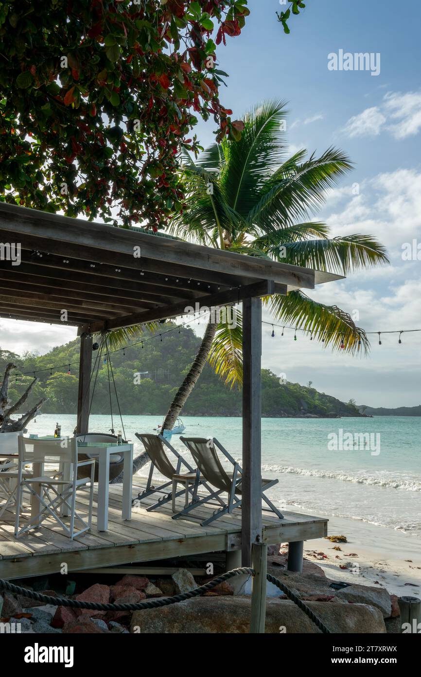 Restaurant and lounge bar on a terrace on the beach on Praslin island, Seychelles Stock Photo