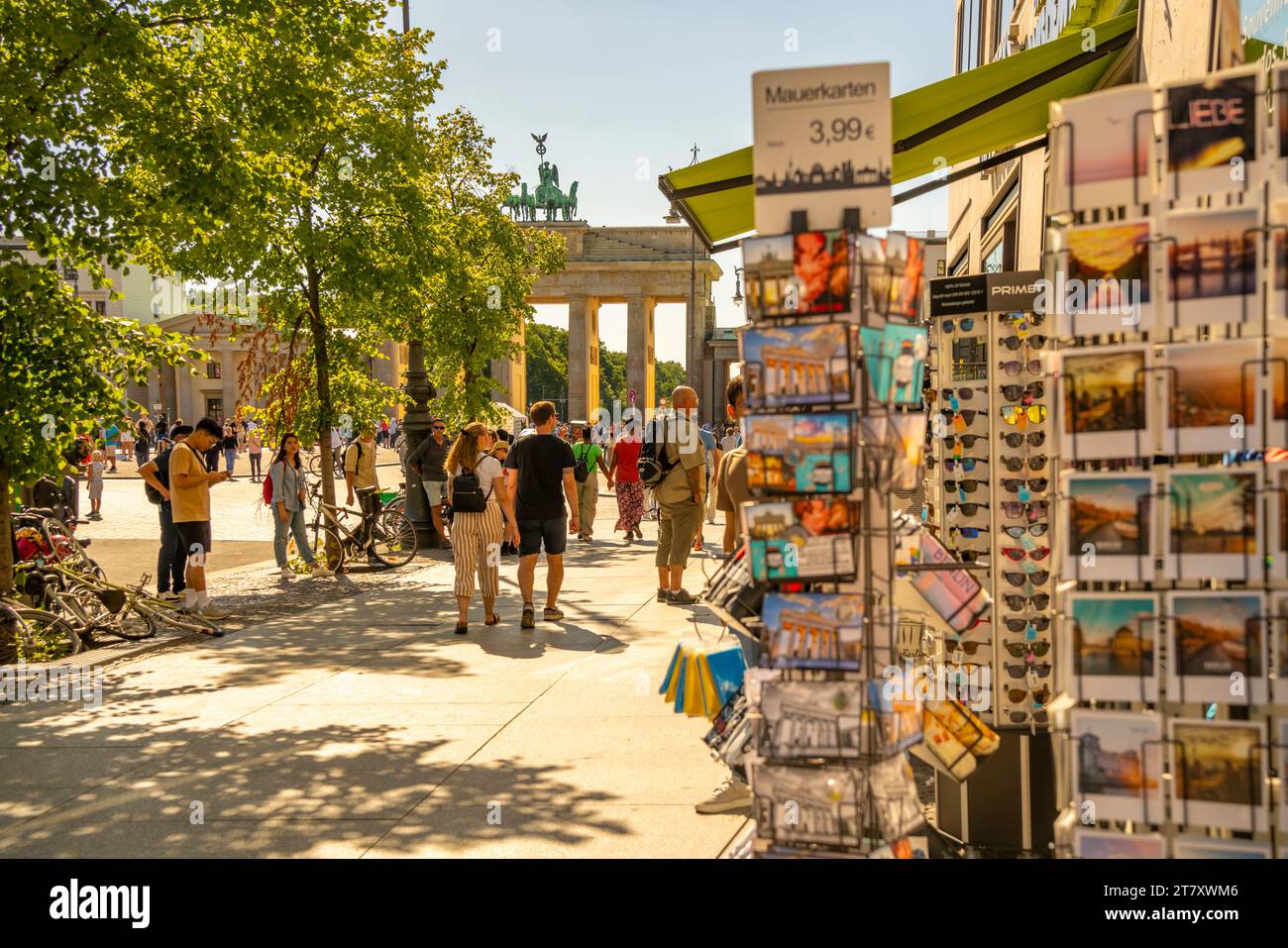 View of Brandenburg Gate, postcards and visitors in Pariser Platz on sunny day, Mitte, Berlin, Germany, Europe Stock Photo