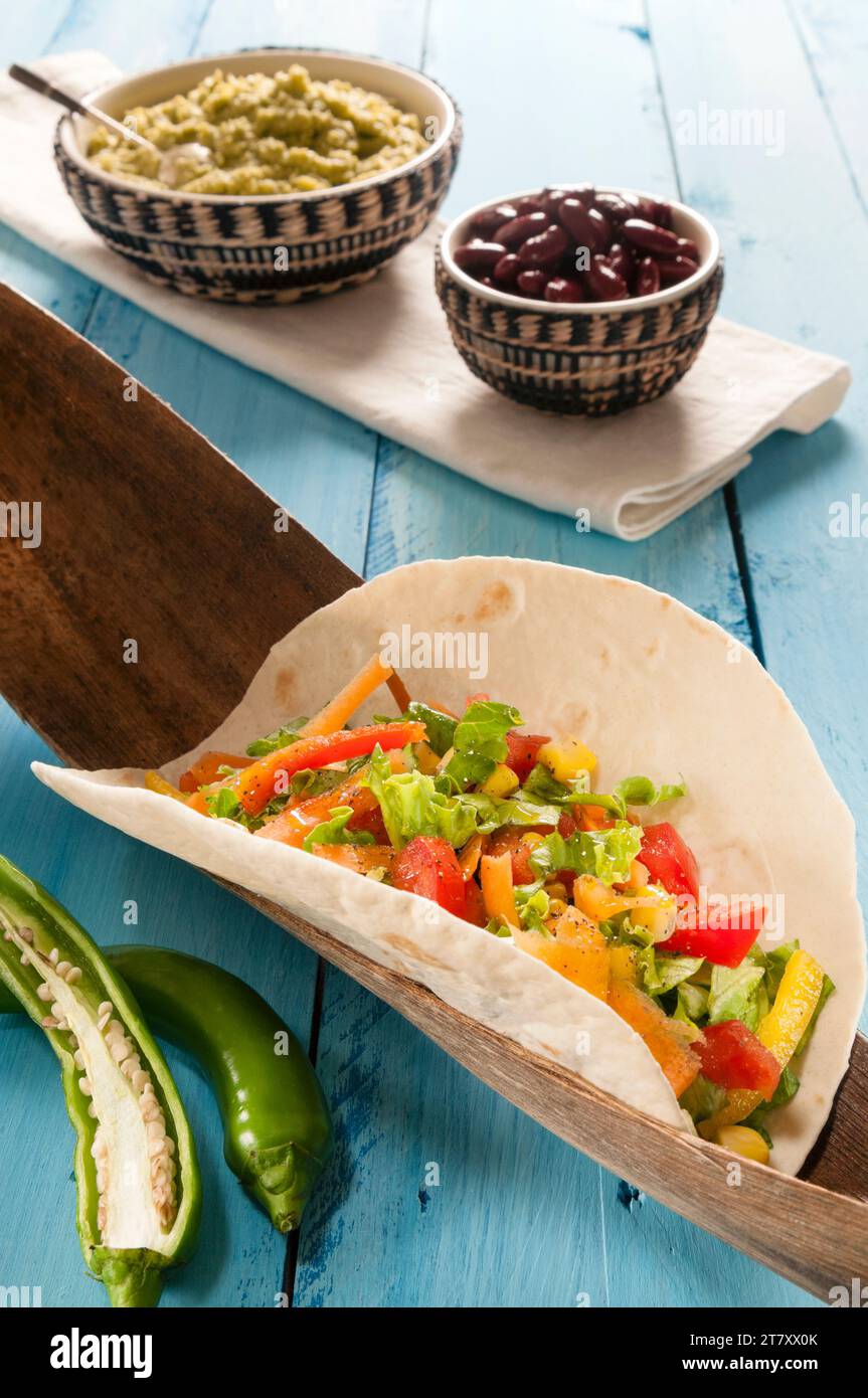 Vegetarian Taco in flour Tortilla with guacamole, hot green peppers and beans, Mexico, North America Stock Photo