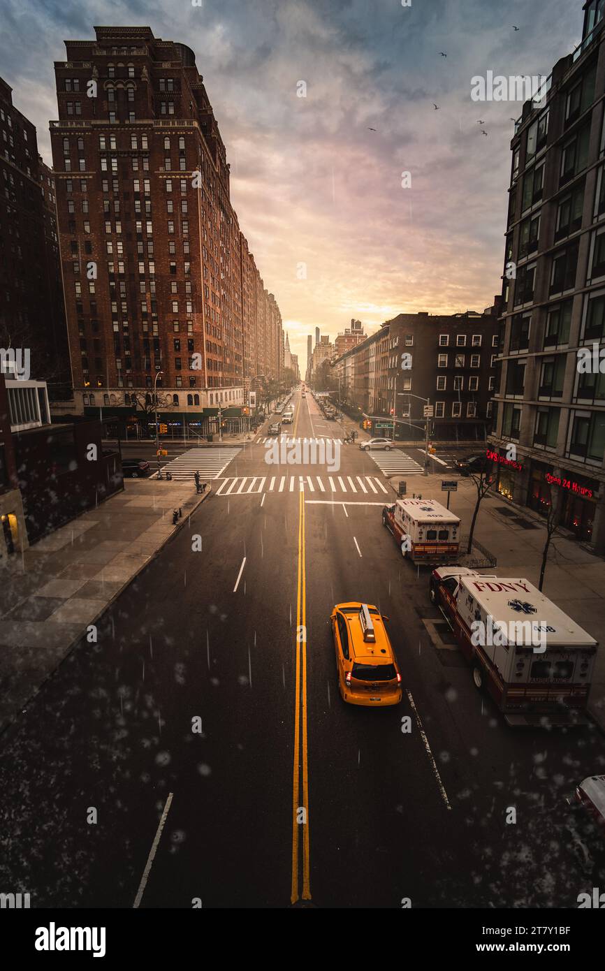 A yellow taxi cab driving along an empty street in a big city Stock ...