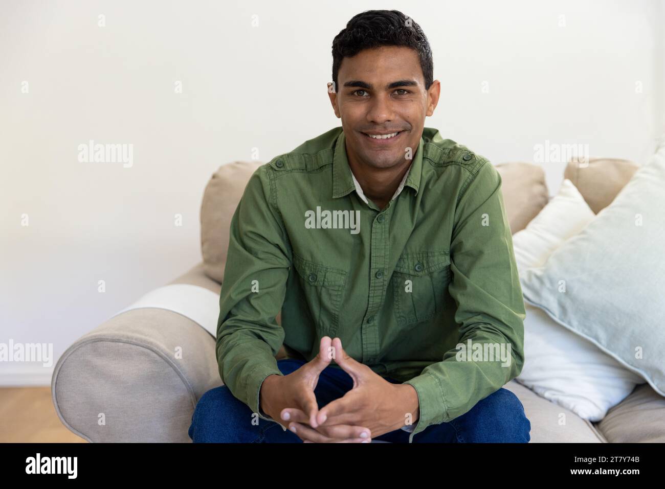 Happy biracial man sitting in hi-res stock photography and images - Alamy