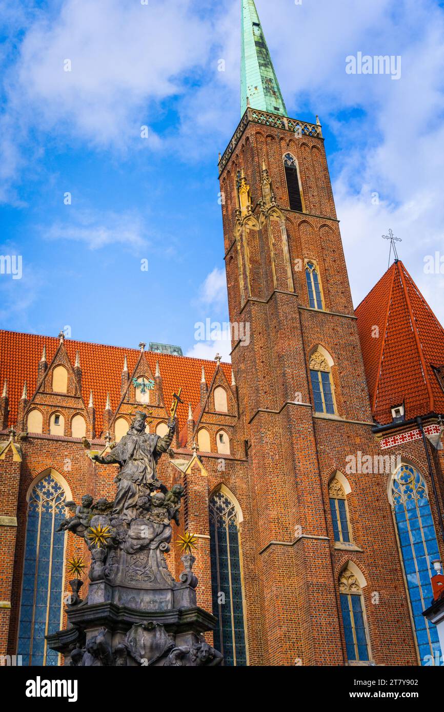 Wrocław, Poland - 16.11.2023: Monument to St. John Nepomuk in front of Collegiate Church of the Holy Cross and St Bartholomew Stock Photo