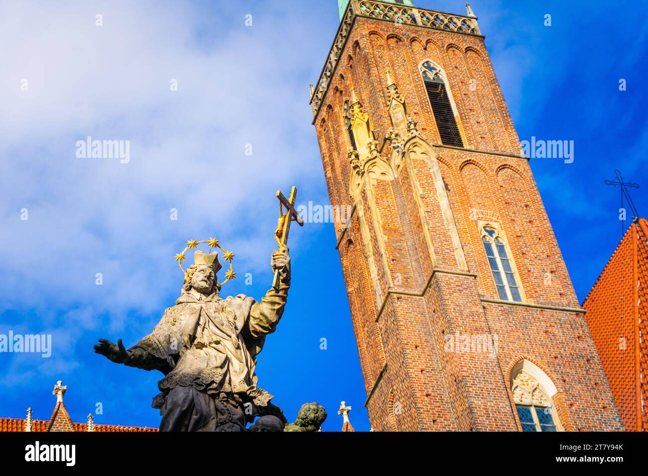 Wrocław, Poland - 16.11.2023: Monument to St. John Nepomuk in front of Collegiate Church of the Holy Cross and St Bartholomew Stock Photo
