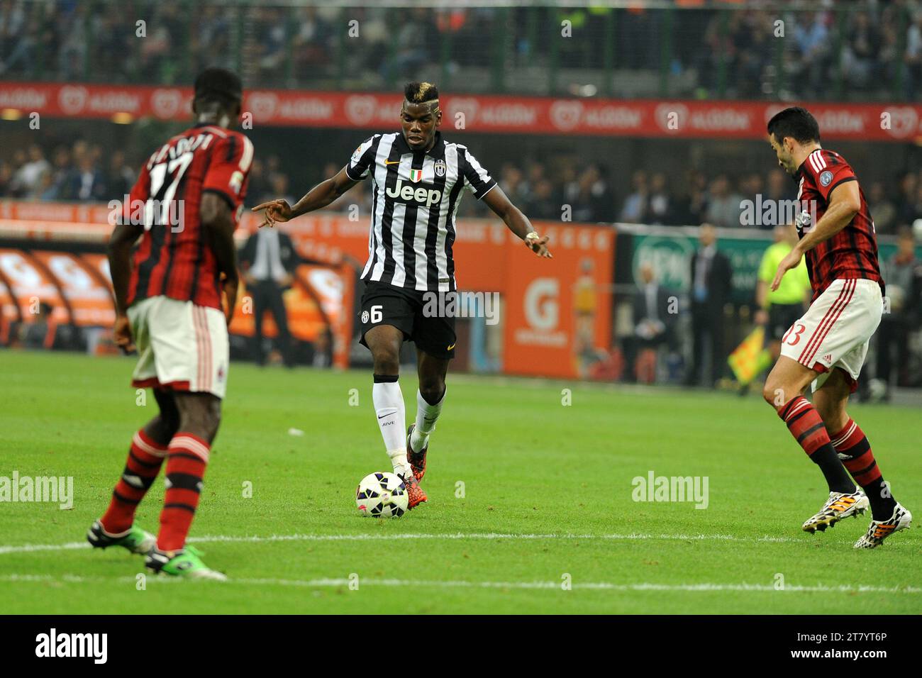 Paul Pogba of Juventus FC controls the ball between Cristian Zapata and Adil Rami of AC Milan during the italian championship Serie A football match between AC Milan and Juventus FC on September 20, 2014 at Giuseppe Meazza Stadium in Milan, Italy. Photo Massimo Cebrelli / DPPI Stock Photo