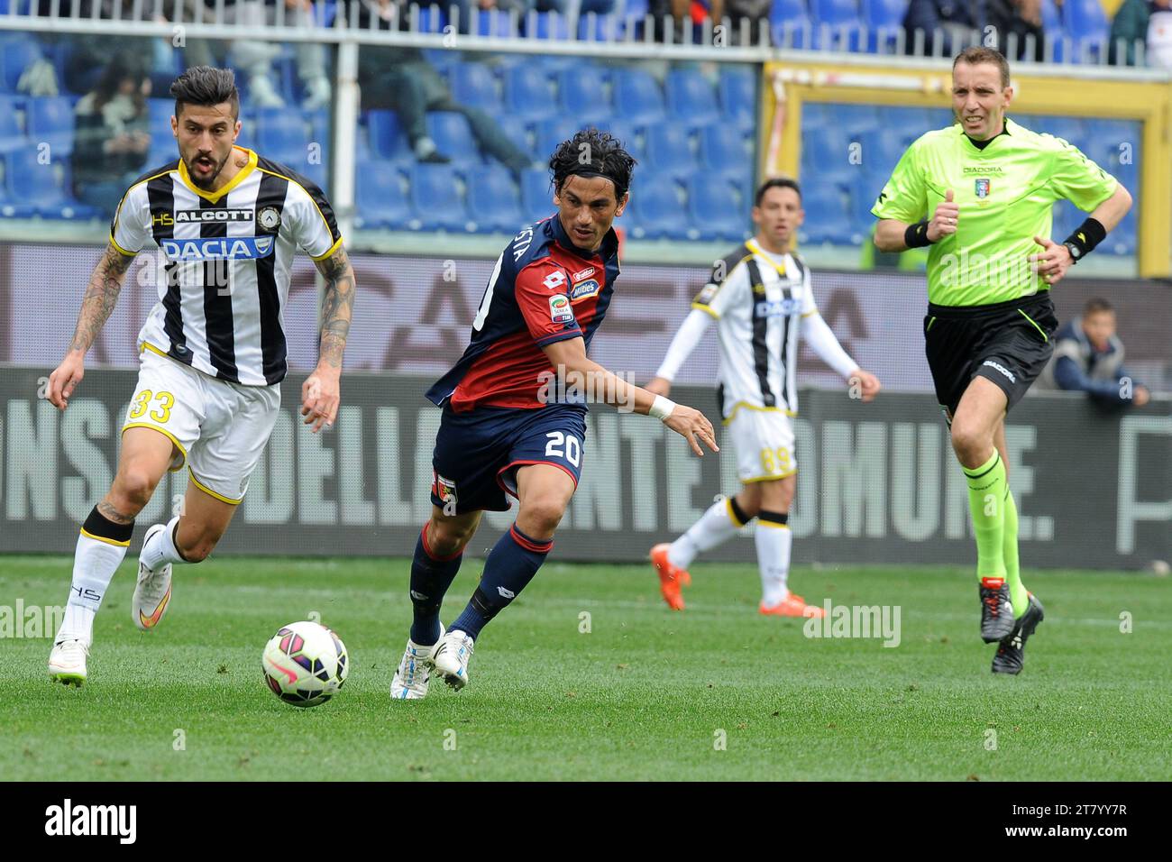 Tino Costa of Genoa CFC and Panagiotis Kone of Udinese Calcio challenge for the ball under eyes Referee Paolo Silvio Mazzoleni during the italian championship 2014/2015 Serie A football match between Genoa CFC and Udinese Calcio at Luigi Ferraris Stadium on April 04, 2015 in Genoa, Italy. Photo Massimo Cebrelli/DPPI Stock Photo