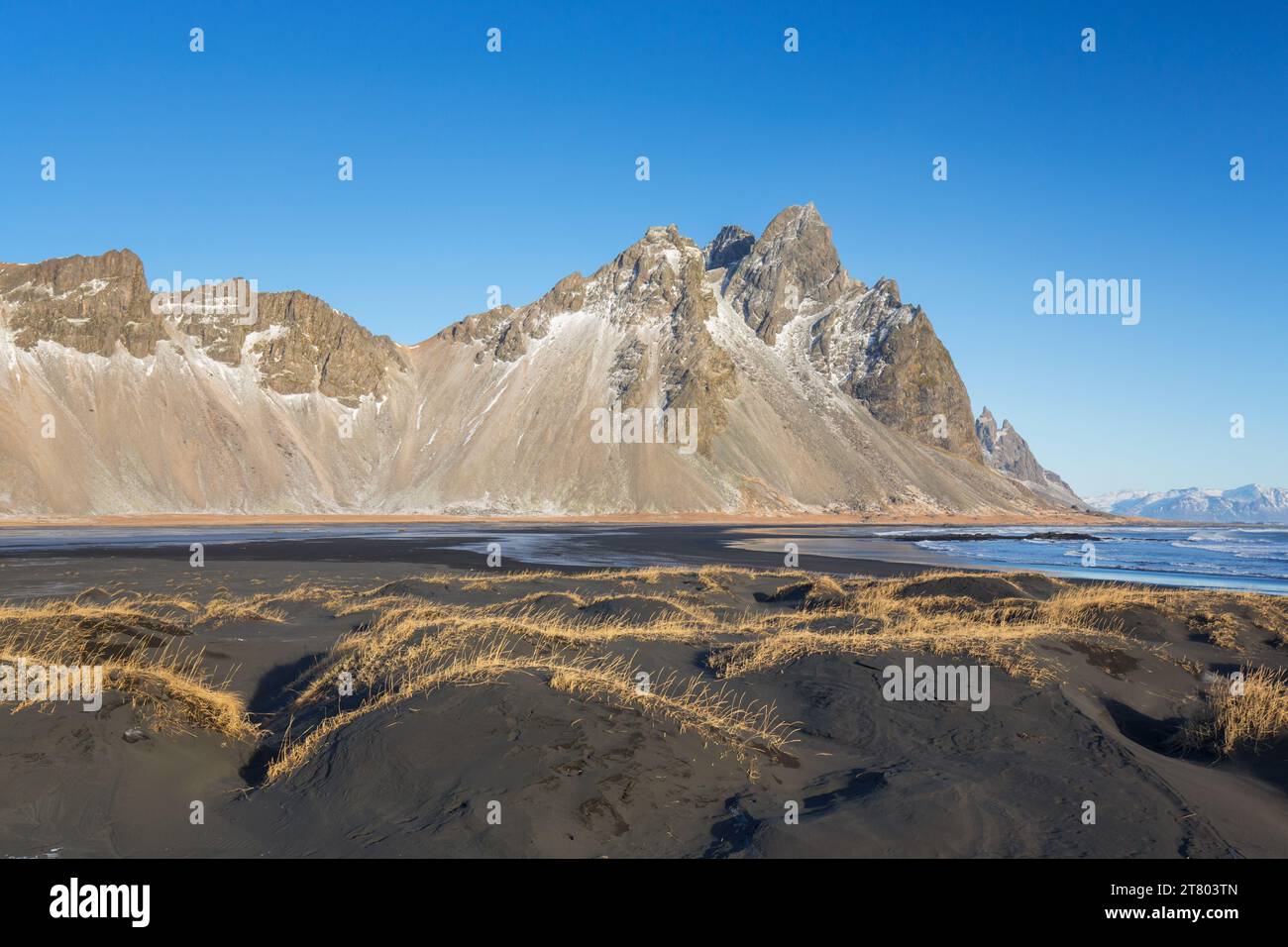 Vestrahorn / Vesturhorn, scree mountain made of gabbro and granophyre rocks, part of the Klifatindur mountain range at Stokksnes in winter, Iceland Stock Photo