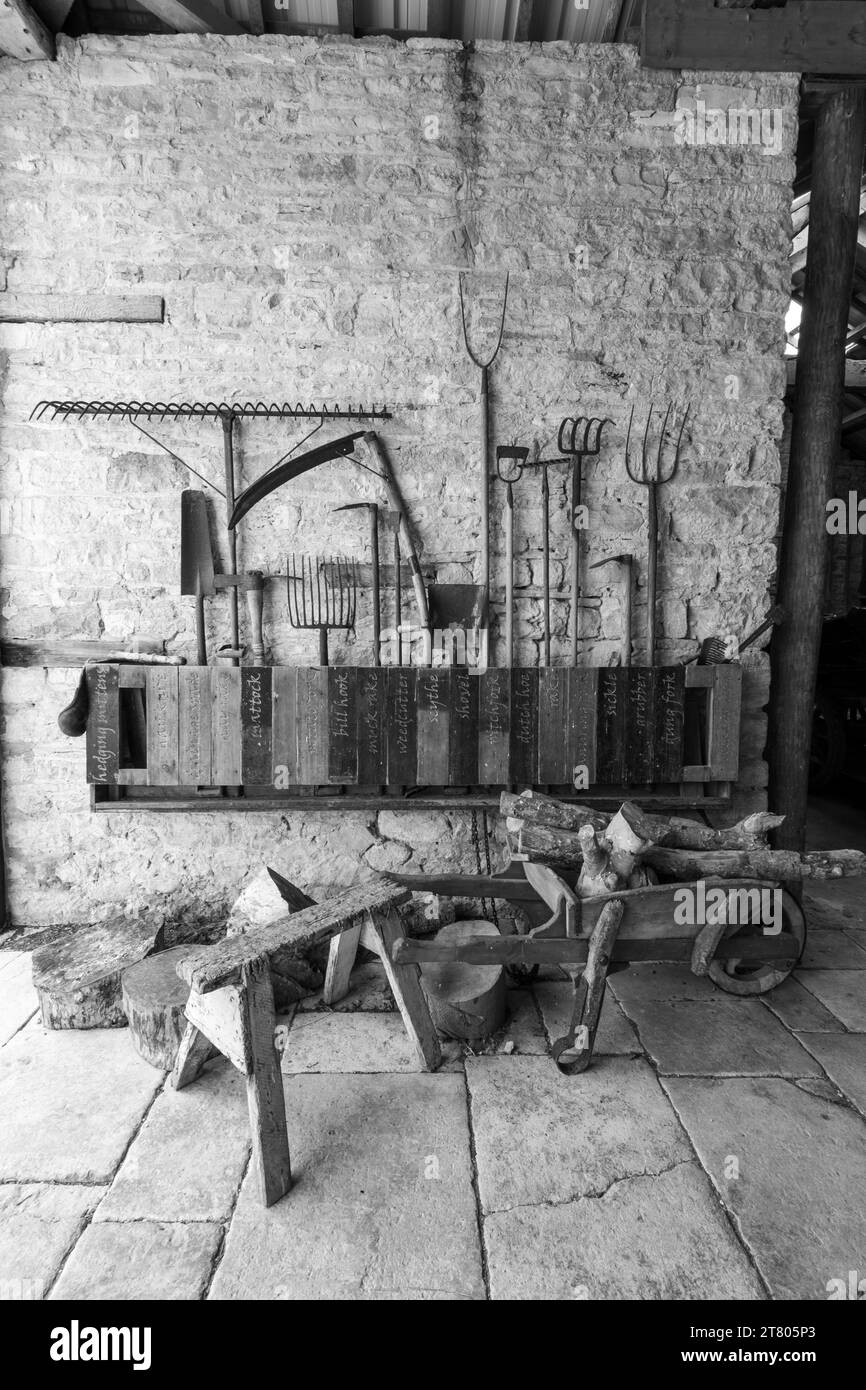 Photo of a selection of antique farm tools inside the barn atTyneham