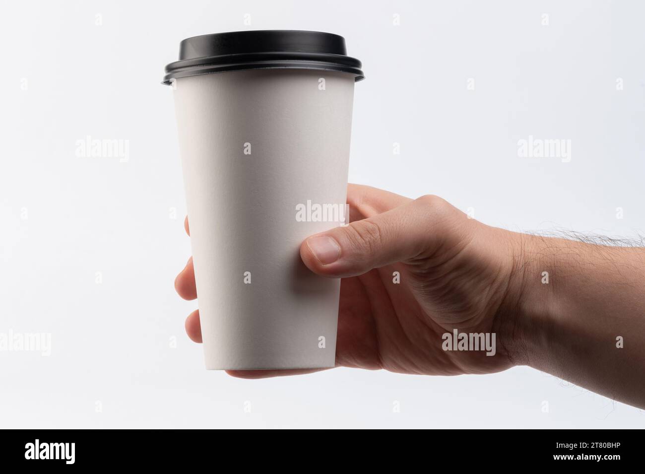 https://c8.alamy.com/comp/2T80BHP/white-paper-disposable-cup-in-hand-close-up-view-isolated-2T80BHP.jpg