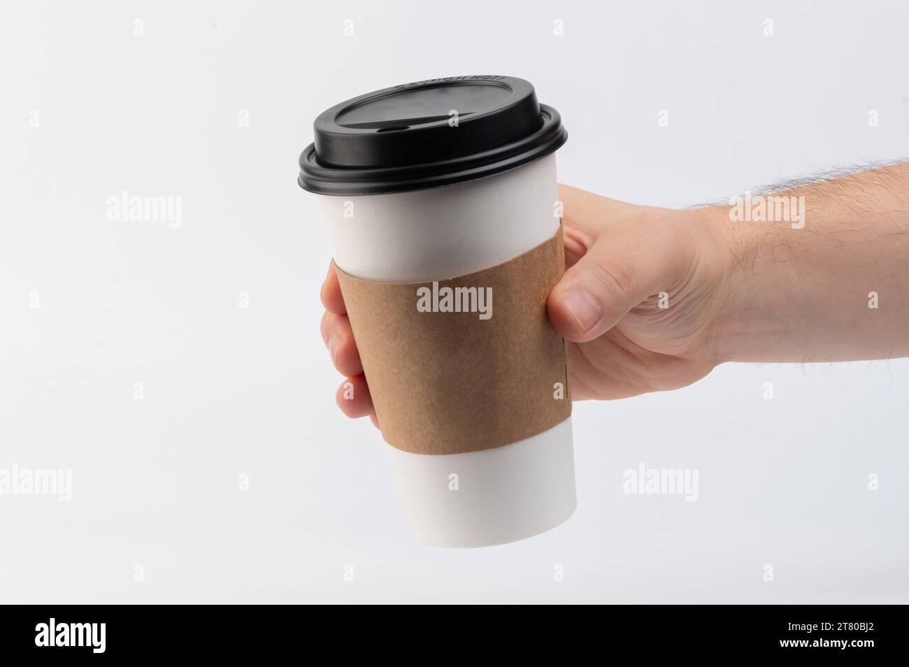 Hand hold paper coffee cup for takeaway coffee isolated on white studio ...