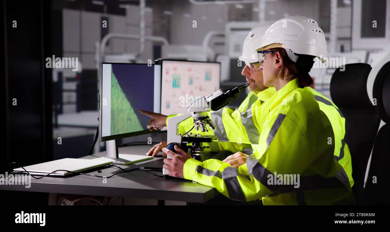 Worker in Electronic Device Factory Analyzing Data Chip at Lab Stock Photo