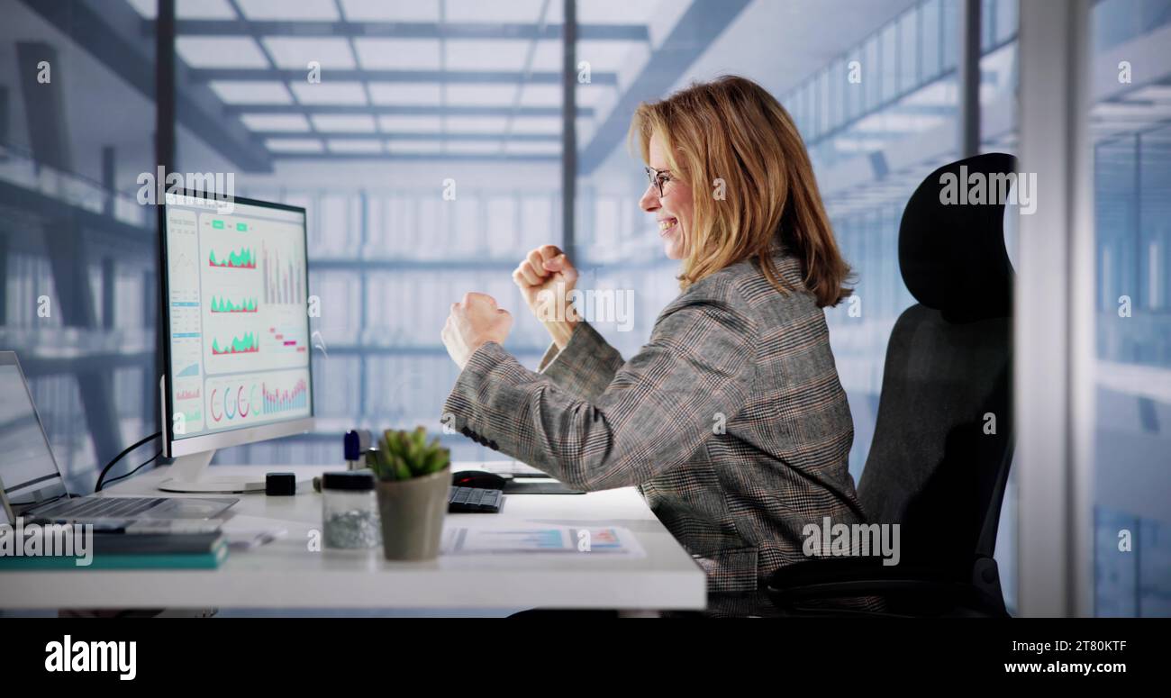 Excited Business Analyst Using Computer Data for Finance Stock Photo