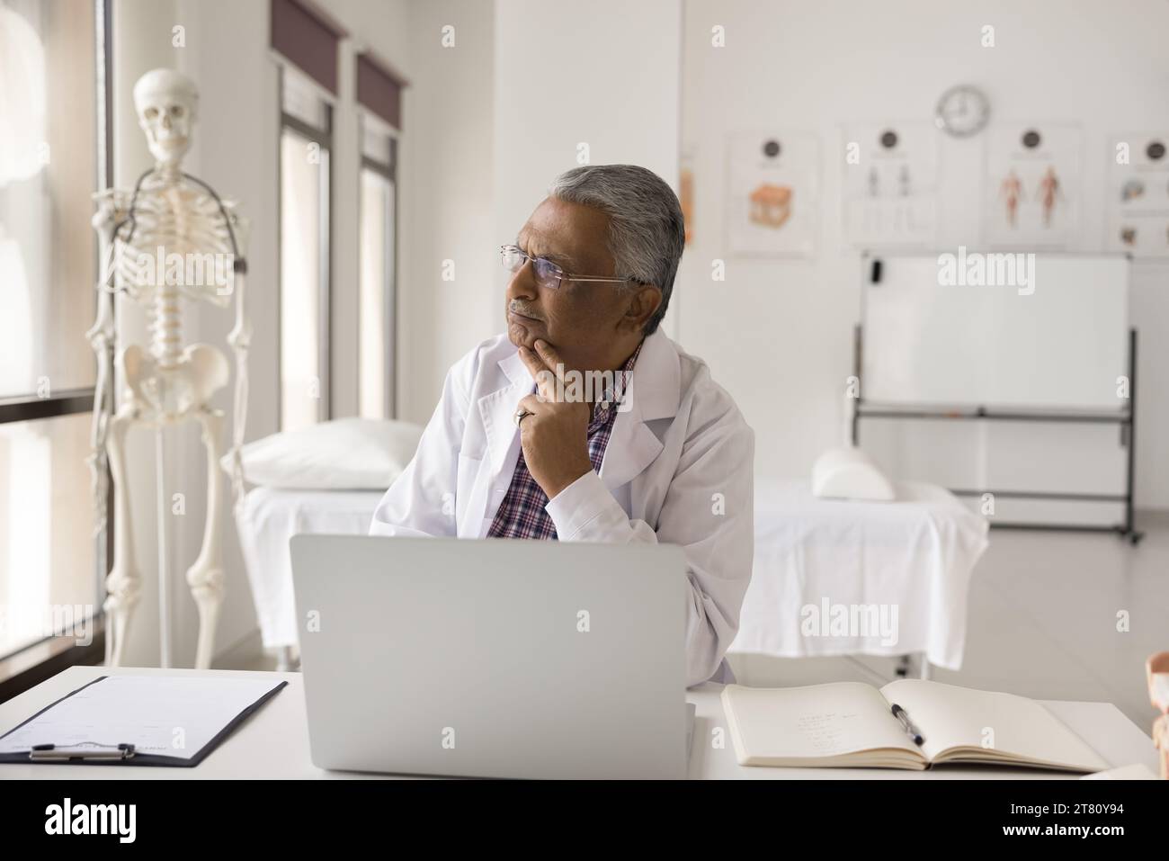 Serious thoughtful senior Indian doctor thinking on job tasks Stock ...