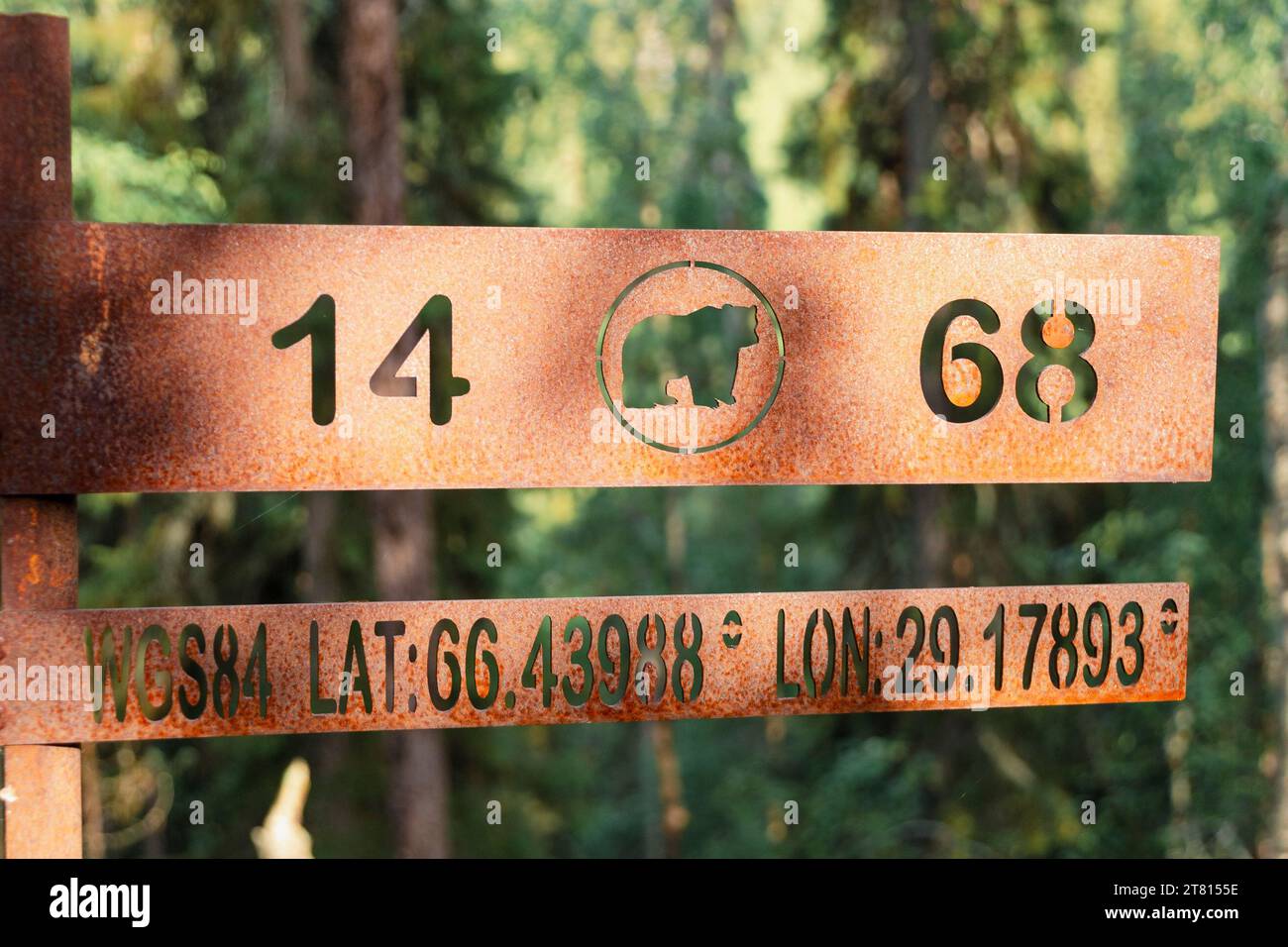 Lat Sign A metal sign on a hiking trail shows the lat and long on the Bear trail ...
