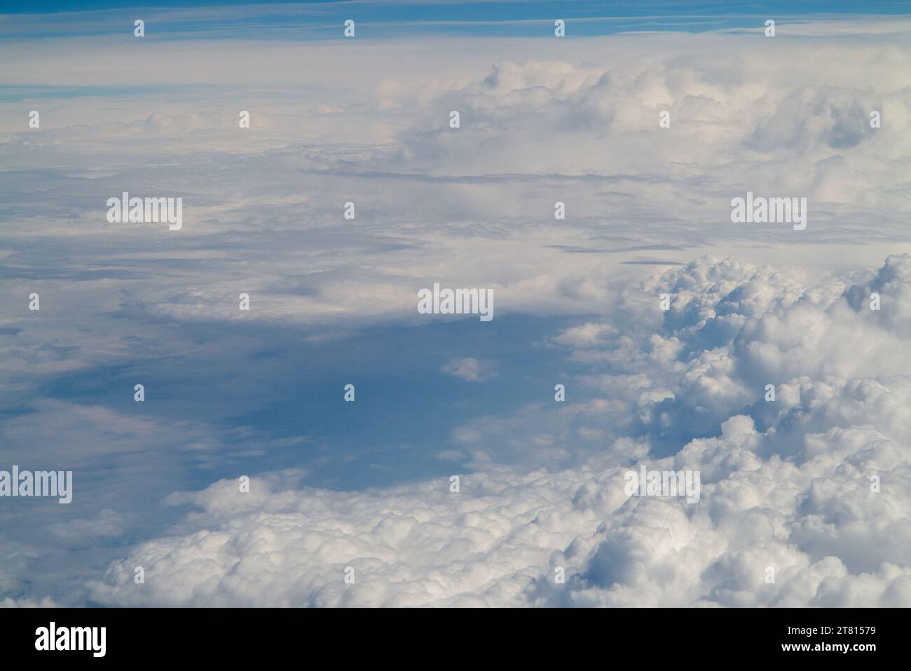 view above clouds from airplane window, above the clouds Stock Photo