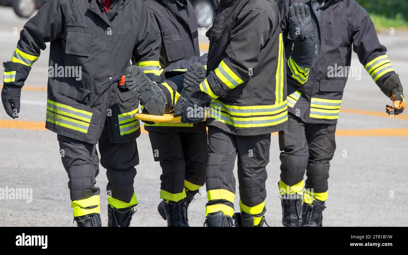 Group Of Firefighters Transports The Stretcher With The Seriously ...