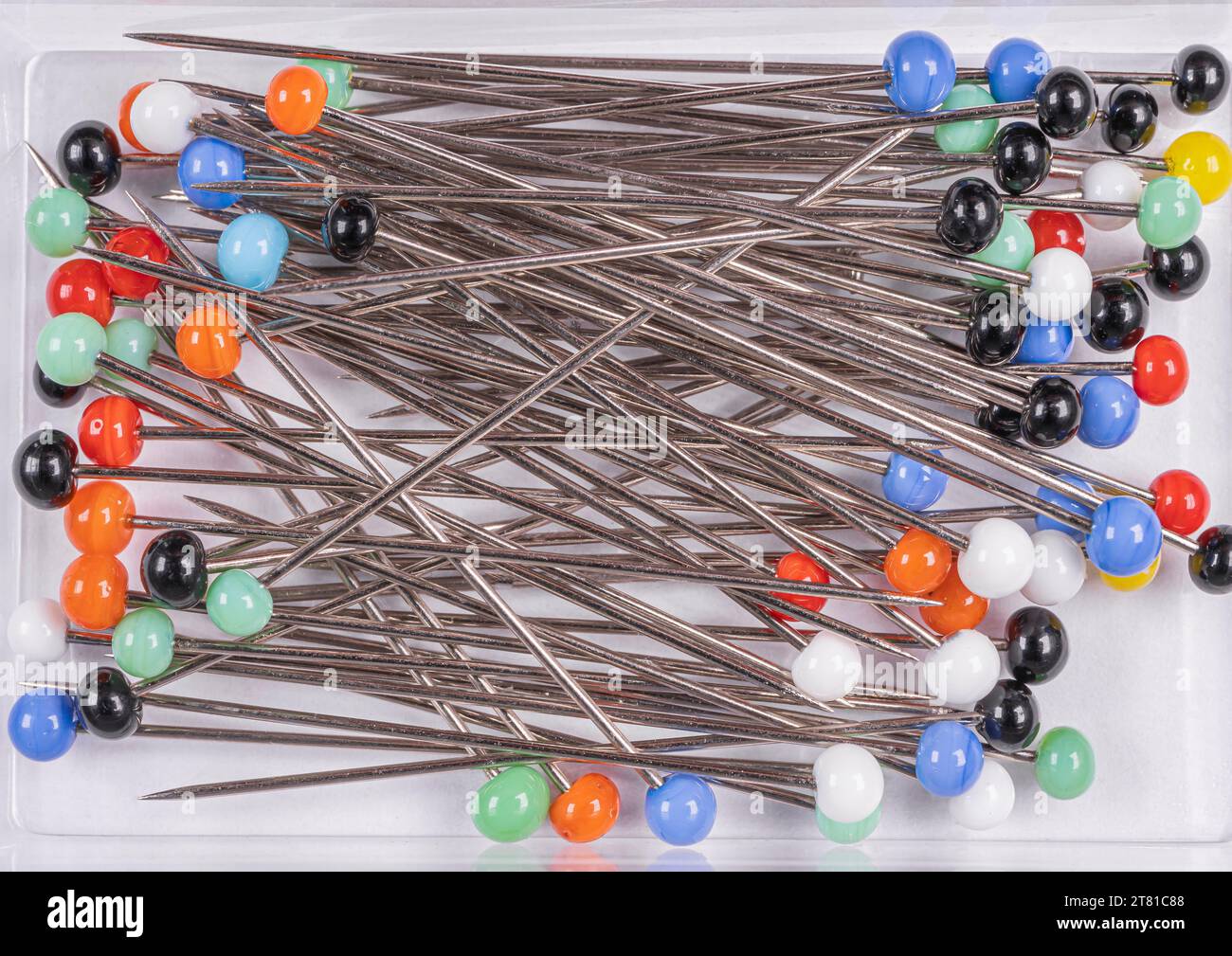 Many multicolored sewing pins on a white background Stock Photo Alamy