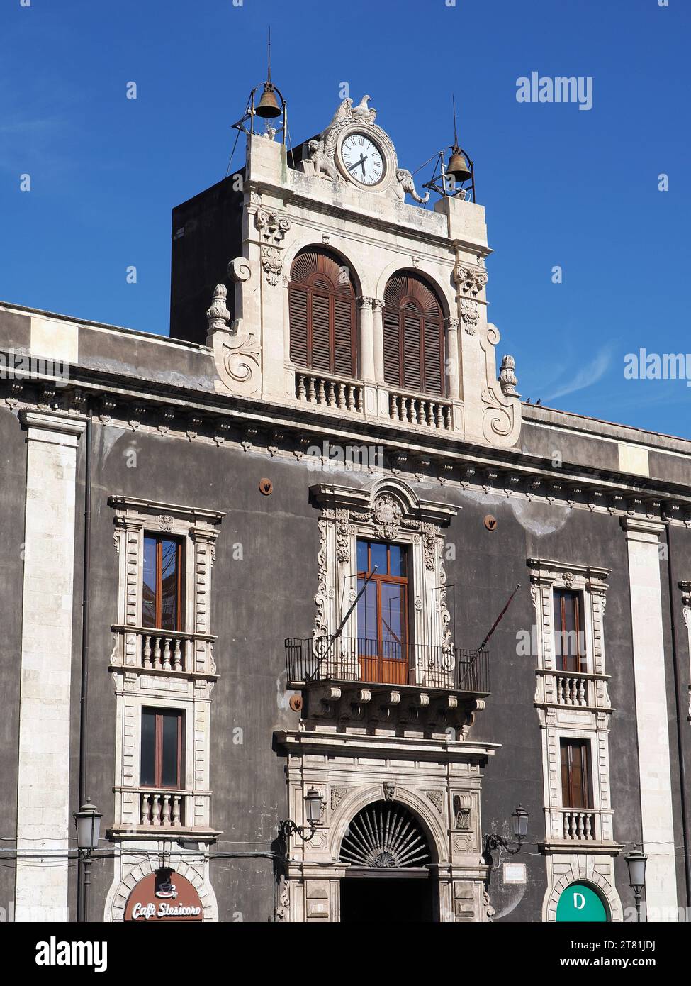 An elderly Sicilian couple walking under a large advertisement of Guess  clothing shop at the Palazzo Tezzano in Catania, Italy Stock Photo - Alamy