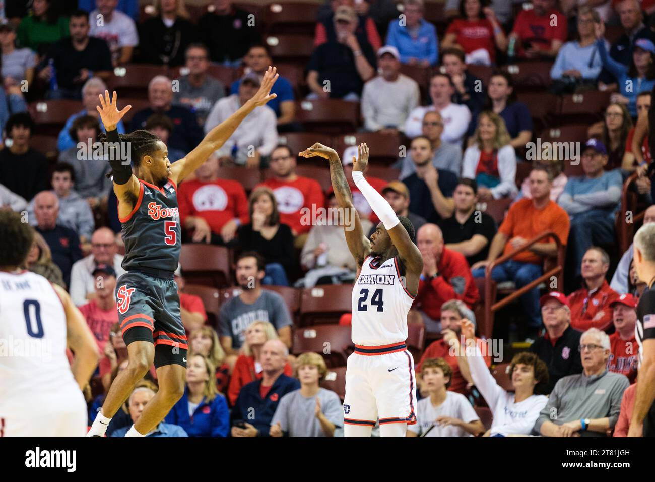 Charleston, South Carolina, USA. 17th Nov, 2023. Dayton Flyers guard KOBE ELVIS (24) shoots for three St. John's Red Storm guard DANISS JENKINS (5) jumps attempting to block ELVIS's shot during the Semi Final game of the Charleston Classic at TD Arena (Credit Image: © Maxwell Vittorio/ZUMA Press Wire) EDITORIAL USAGE ONLY! Not for Commercial USAGE! Stock Photo