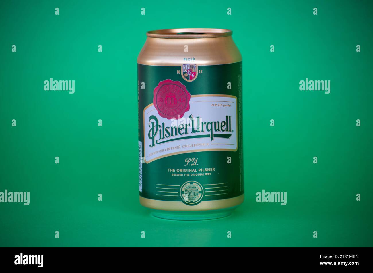 MALAGA, SPAIN - NOVEMBER 17, 2023: Bottle of Pilsner Urquell beer on green background in Malaga, Spain on November 17, 2023 Stock Photo