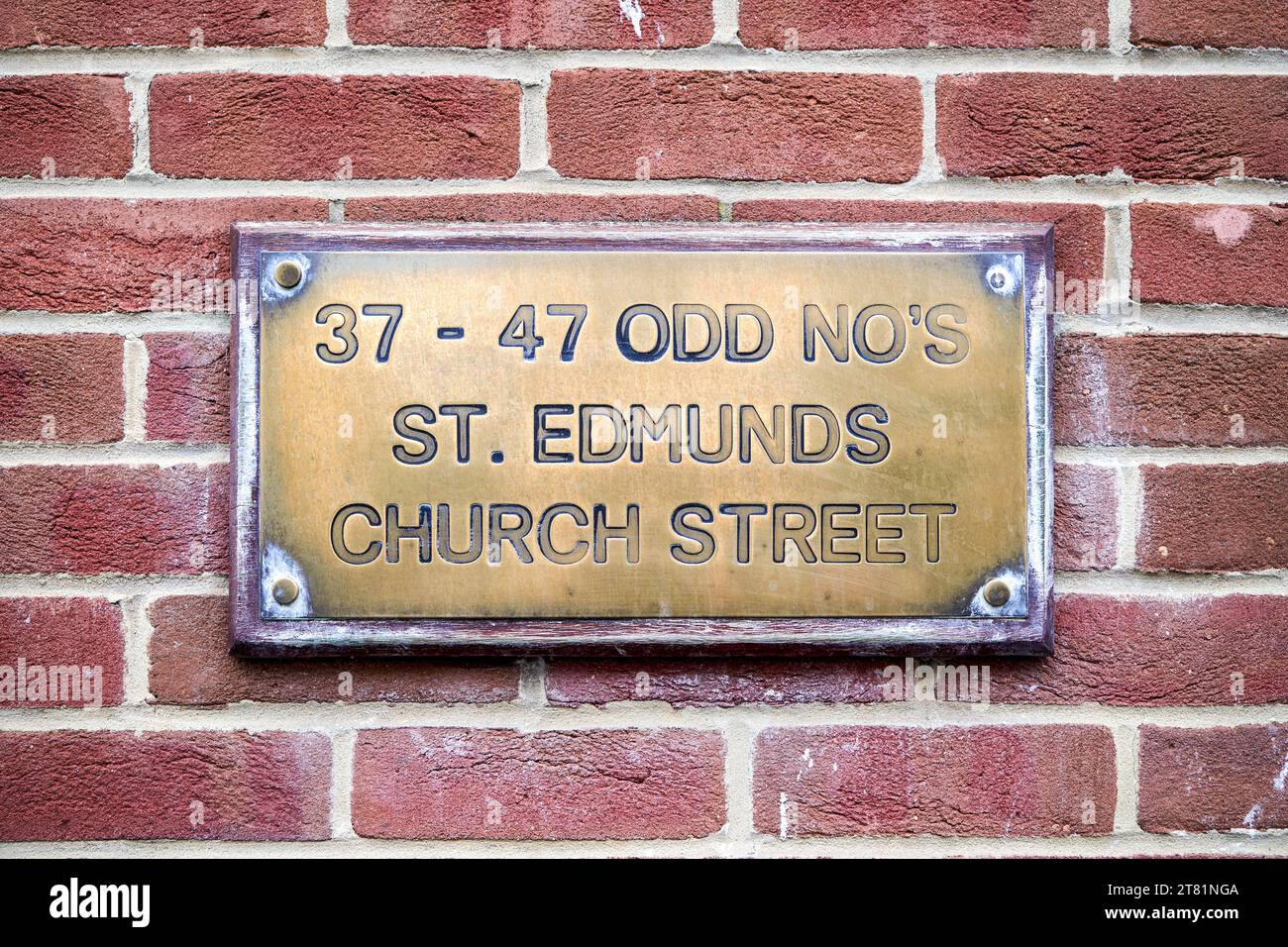 Brass plaque showing odd number addresses and street name Stock Photo