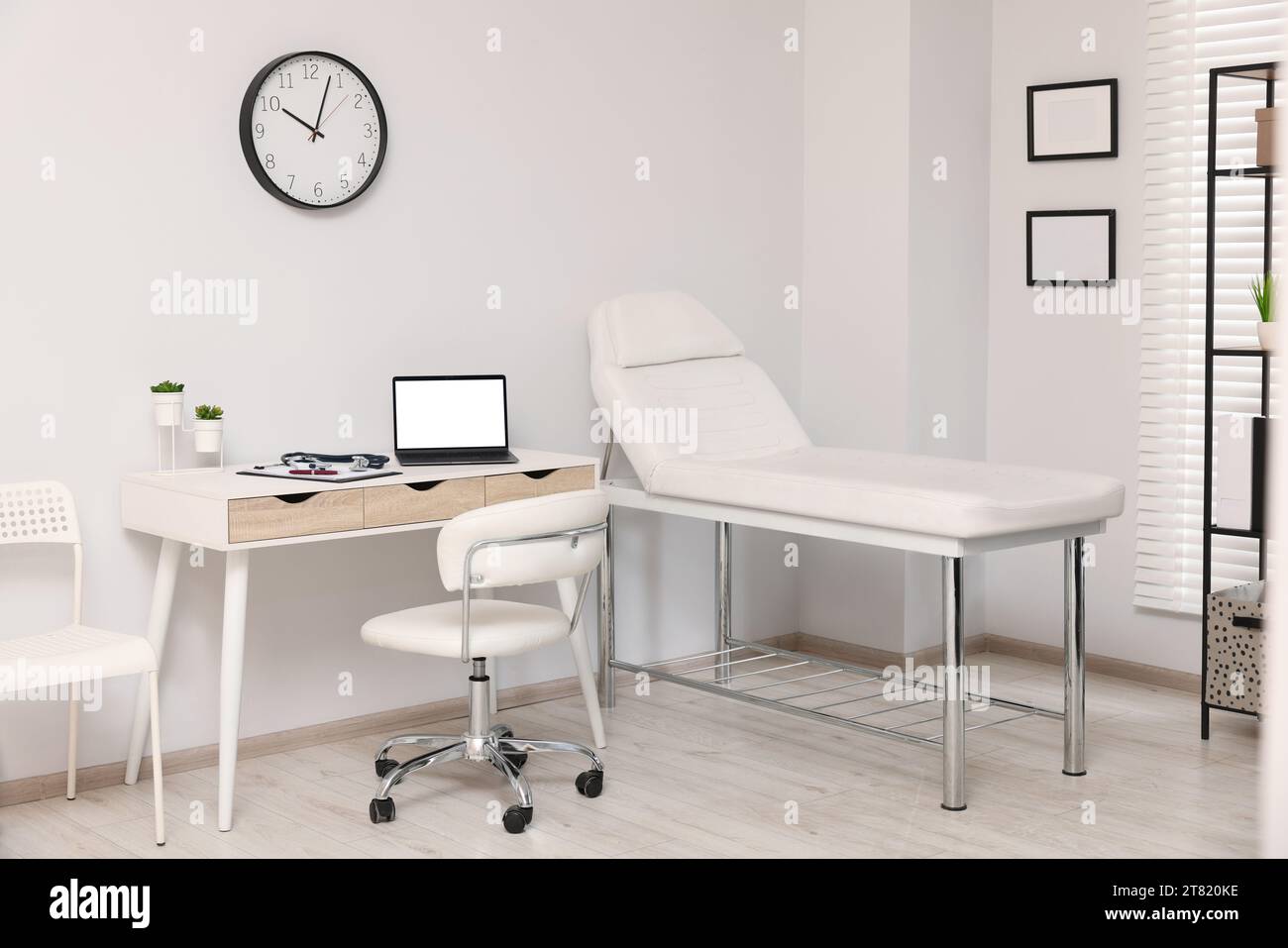 Modern medical office with doctor's workplace and examination table in ...