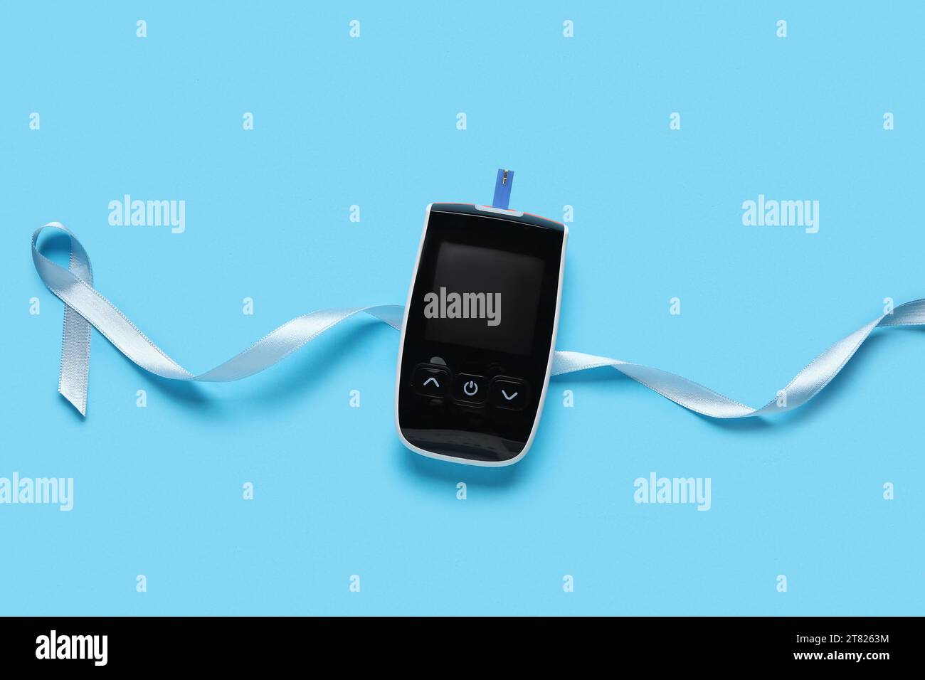 Awareness ribbon with glucometer on blue background. Diabetes concept ...