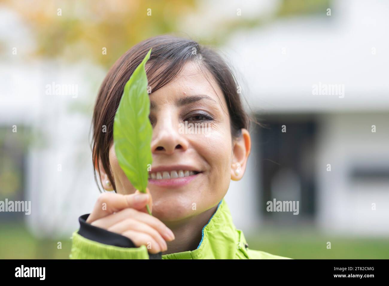 Woman with a plant in front of her face Environmental protection Stock ...