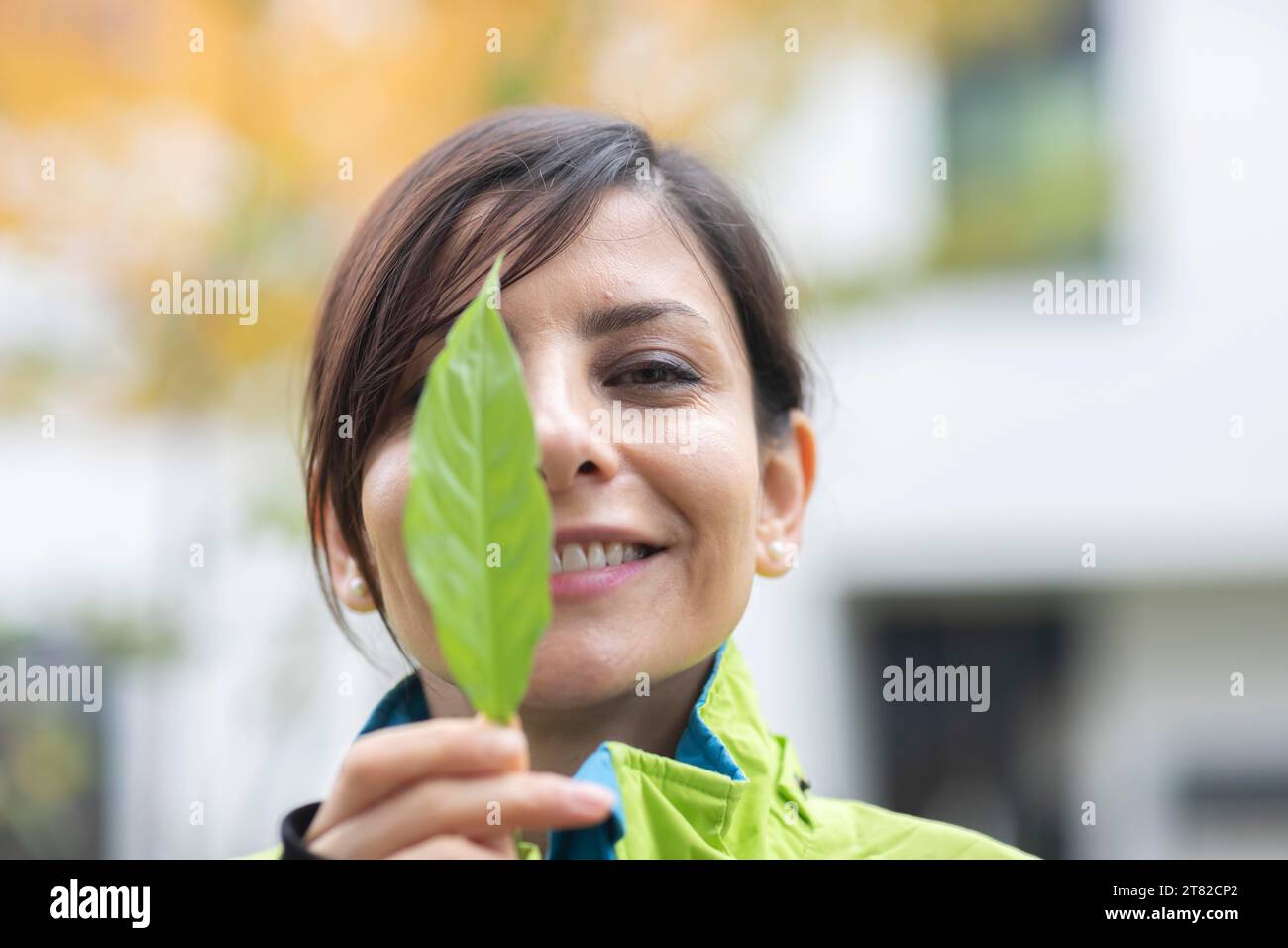 Woman with a plant in front of her face Environmental protection Stock ...