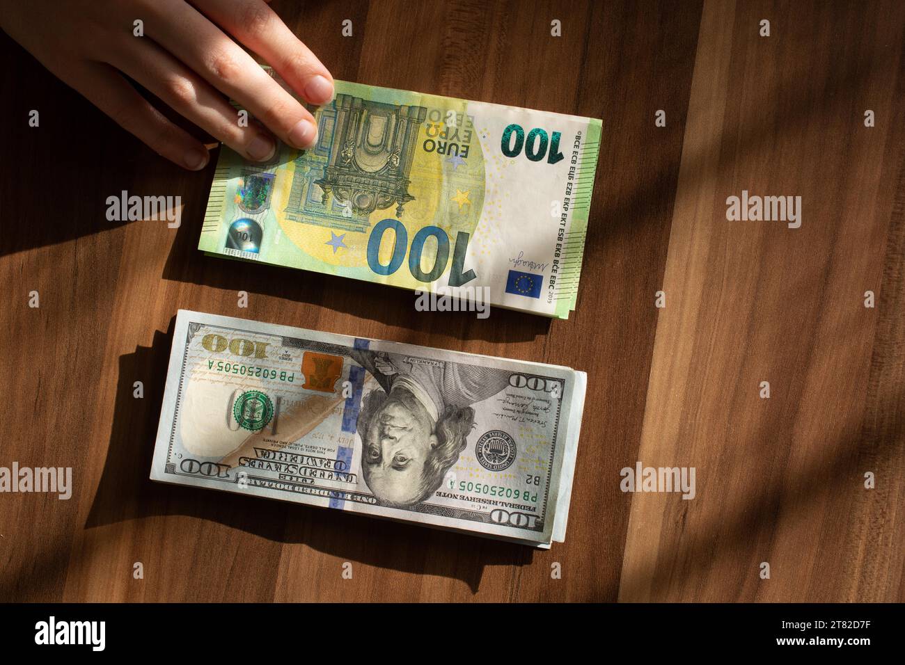 Dollar bills American money cash. Euro, currency of European Union. One hundred usd dollars banknotes. Financial and economic crisis Stock Photo