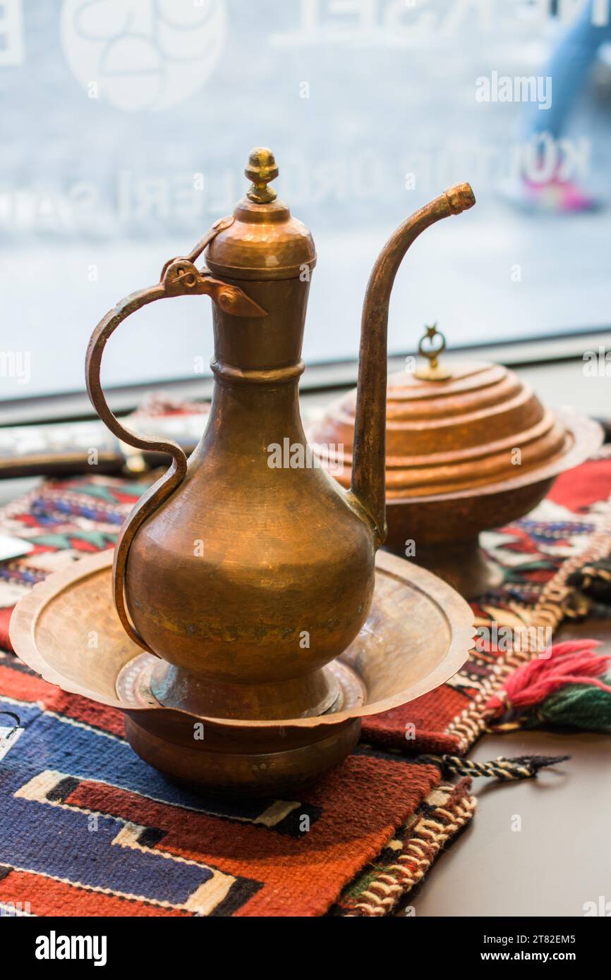 Ancient metal jug in oriental style in antique market Stock Photo