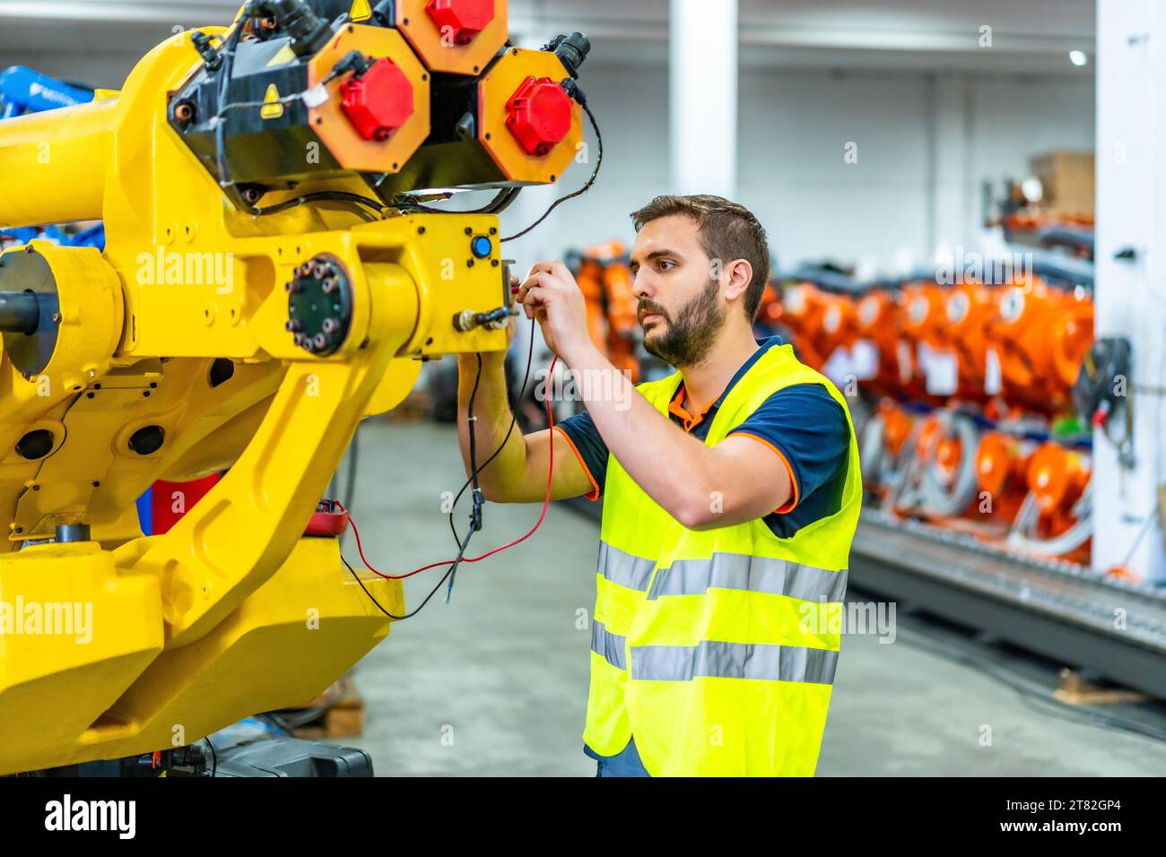 Mechanical engineer inspecting and fixing a mechanical arm on an