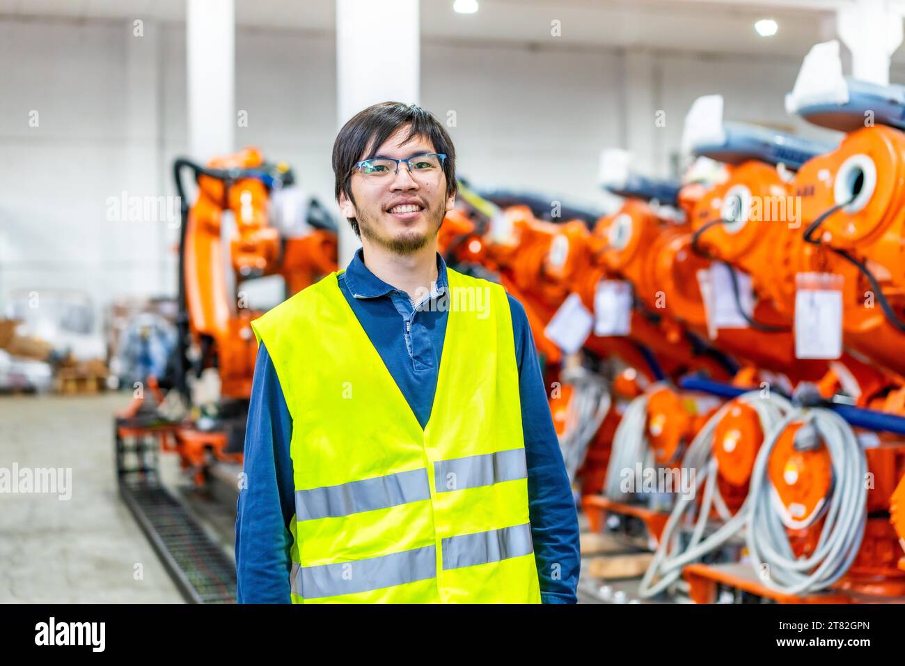 Portrait of a proud japanese chief engineer of a robotic arm production factory Stock Photo