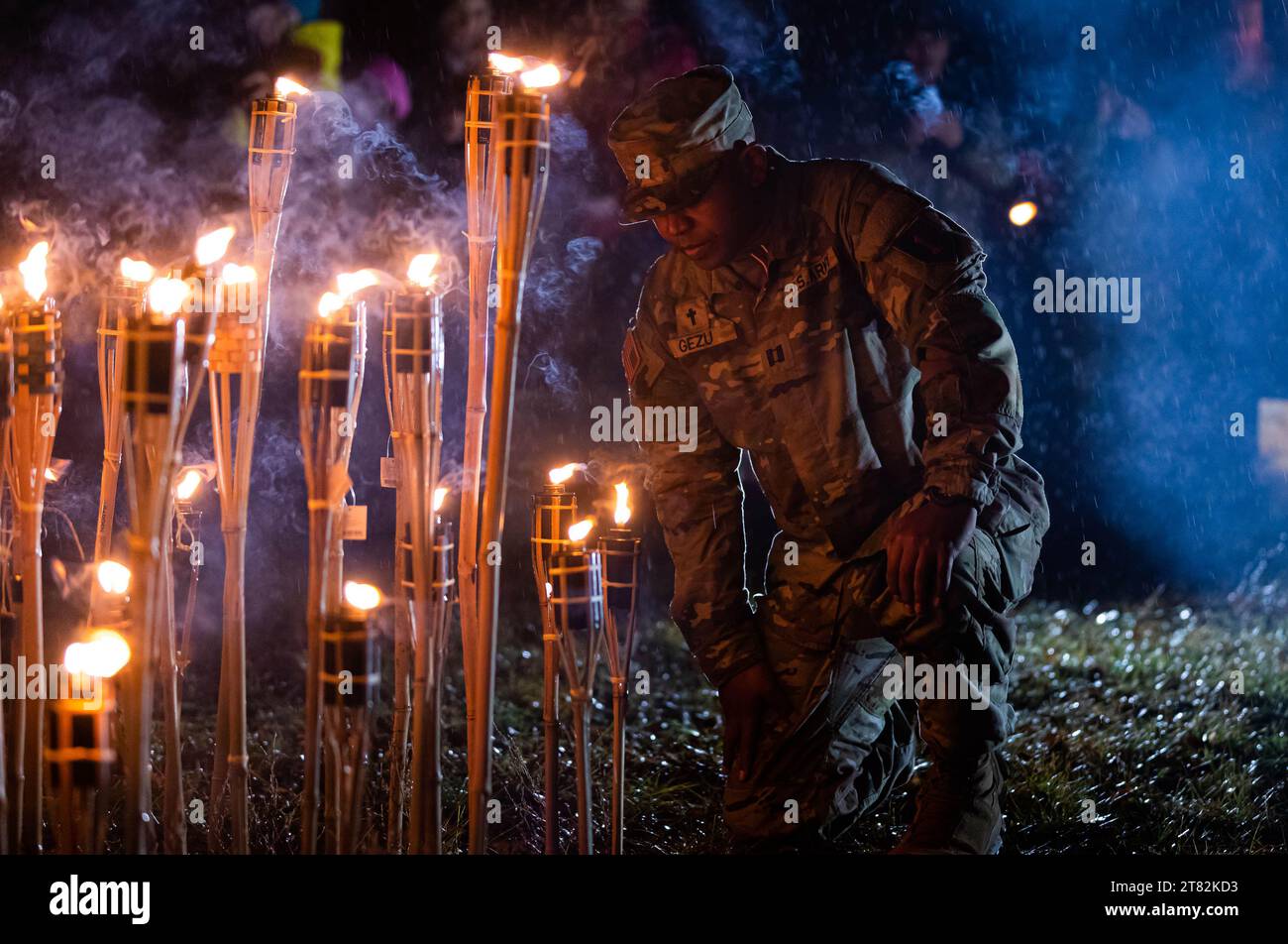 Adazi, Latvia. 11th Nov, 2023. U.S. Army Capt. Assefa Gezu, a chaplain with 2nd General Support Aviation Battalion, 1st Aviation Regiment, 1st Combat Aviation Brigade, sets his torch in remembrance of past veterans and freedom fighters during Day at Baltezera Church near Adazi, Latvia, November. 11, 2023. local civilians and Soldiers walk 4.5 kilometers from Culture Center to Baltezera Church, to honor freedom fighters and veterans. The 3rd Infantry Divisionâ mission in Europe is to engage in multinational training and exercises across the continent, working alongside NATO allies and regi Stock Photo