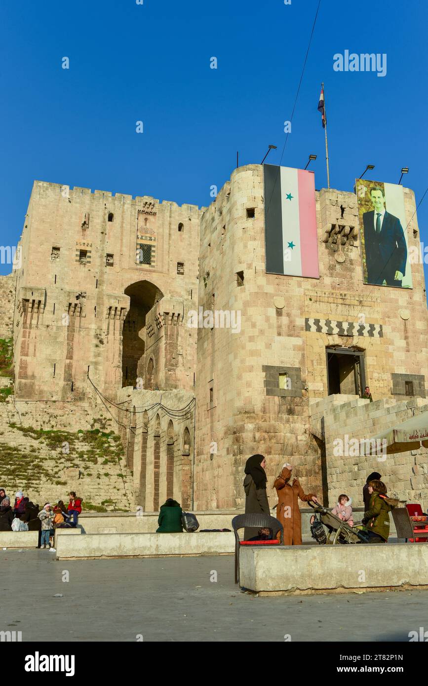 Syrian Flag and photo of Bashar al-Assad on the front gate of the Citadel of Aleppo, one of the oldest and largest castles in the world Stock Photo