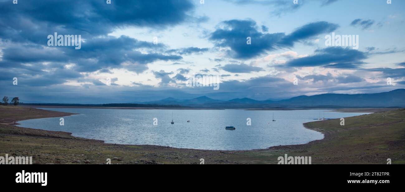 Leisure boats anchored on the shore of the Gabriel y Galan reservoir, Caceres, Spain. Active tourism at freshwaters coasts concept Stock Photo