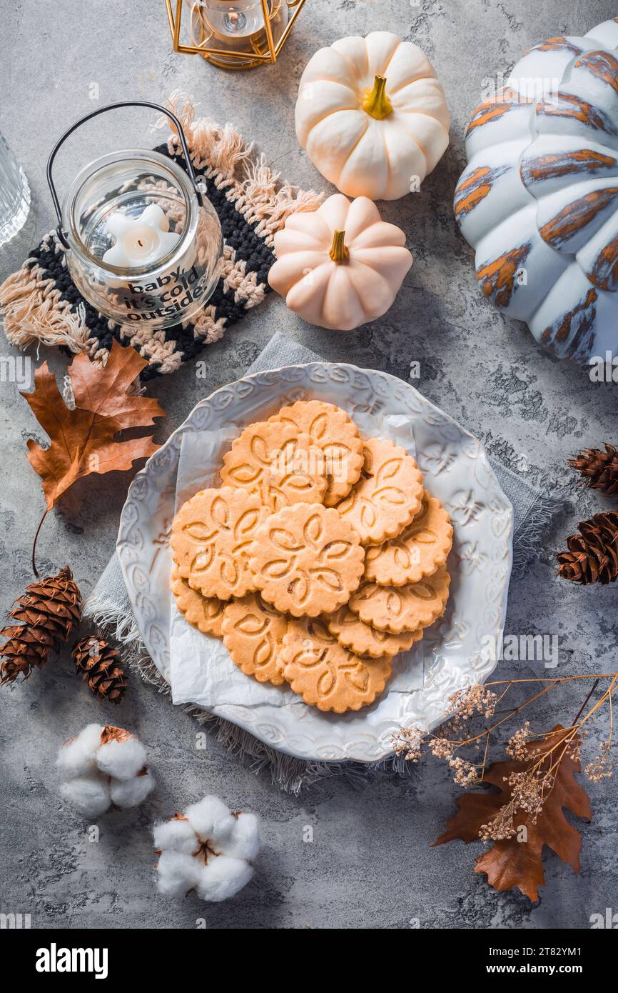 Chai latte cookies or ginger biscuits with pumpkins and candles for autumn season Stock Photo