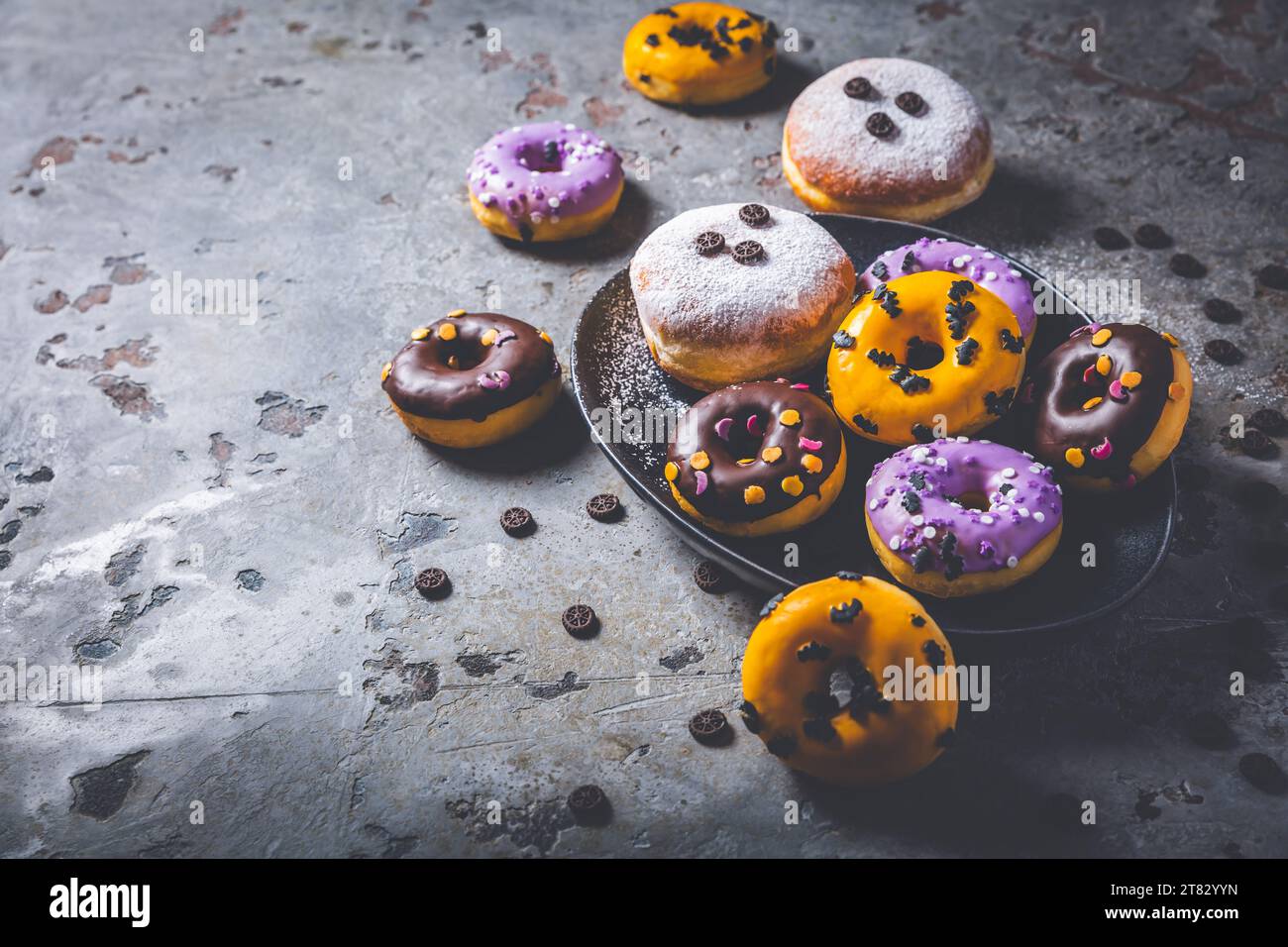 Halloween donuts and Berliner with assorted frosting and sugar sprinkles for Halloween and carnival Stock Photo